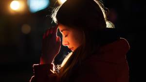 web-woman-praying-night-light-face-tymonko-galyna-shutterstock_404562580-2