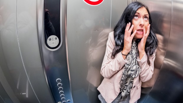 WEB3 CLAUSTROPHOBIA FEAR OF ELEVATORS WOMAN IN ELEVATOR PHOBIA FEAR Shutterstock