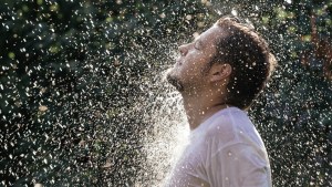 web3-young-handsome-man-in-white-t-shirt-having-shower-in-the-sunny-rain-at-the-summer-garden-shutterstock_307415330