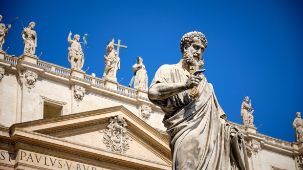 The statue of St. Peter in St. Peter's square with part of the façade of the basilica visible behind