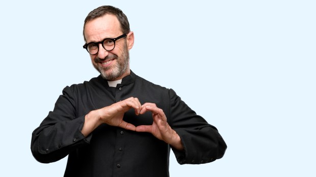 Priest religion man happy showing love with hands in heart