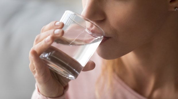 thirsty woman holding glass drinks still water preventing dehydration