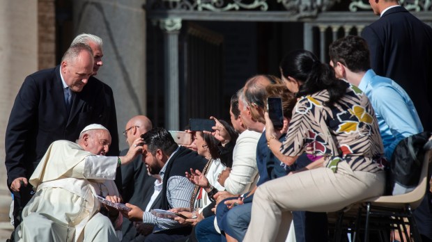 Pope Francis blesses a man at the conclusion of his weekly general audience.