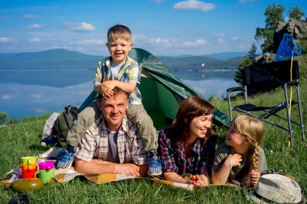 Friendly family outdoors with tent