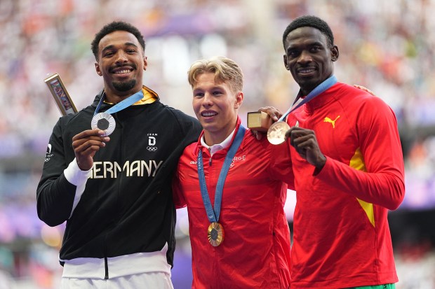 award ceremony second-placed Leo Neugebauer from Germany first-placed Markus Rooth from Norway and third-placed Lindon Victor from Grenada celebrate at the medal ceremony